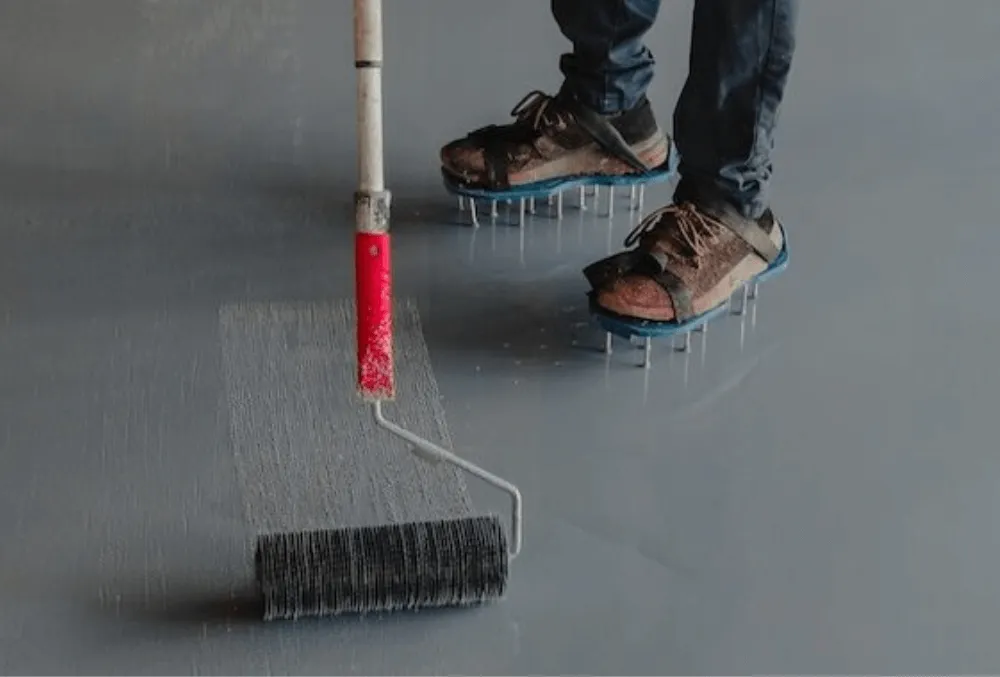 applying epoxy floor coating on a concrete surface