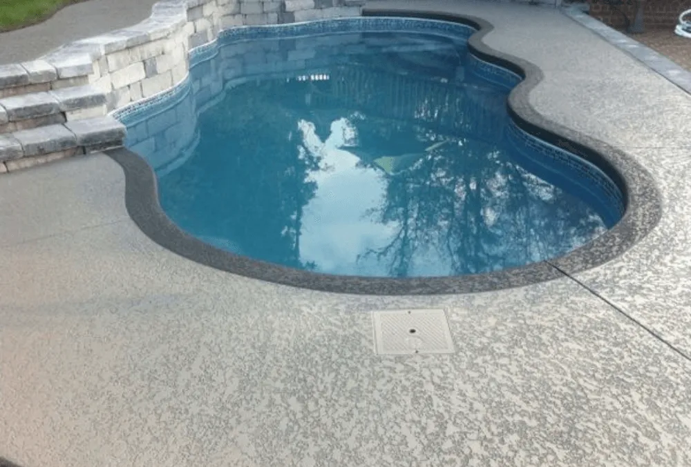 Spray texture pool deck coating with slip-resistant finish and decorative design