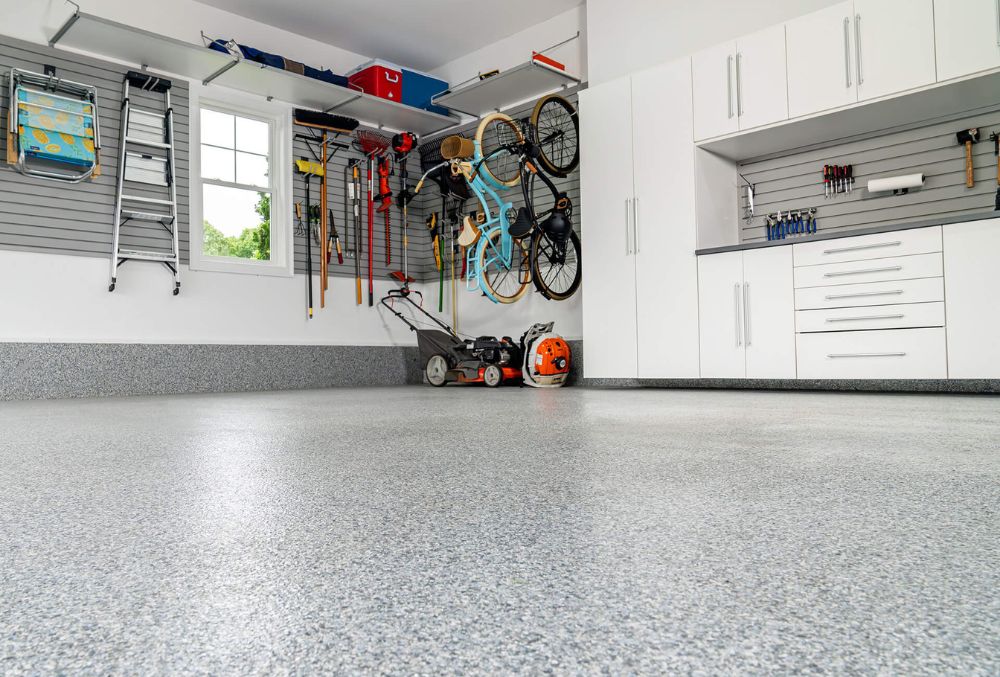 Garage floor coated with durable epoxy, featuring a smooth, glossy surface that resists stains and enhances appearance.