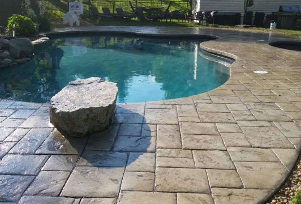 Stamped concrete pool deck in San Jose with natural stone pattern and durable, slip-resistant finish.